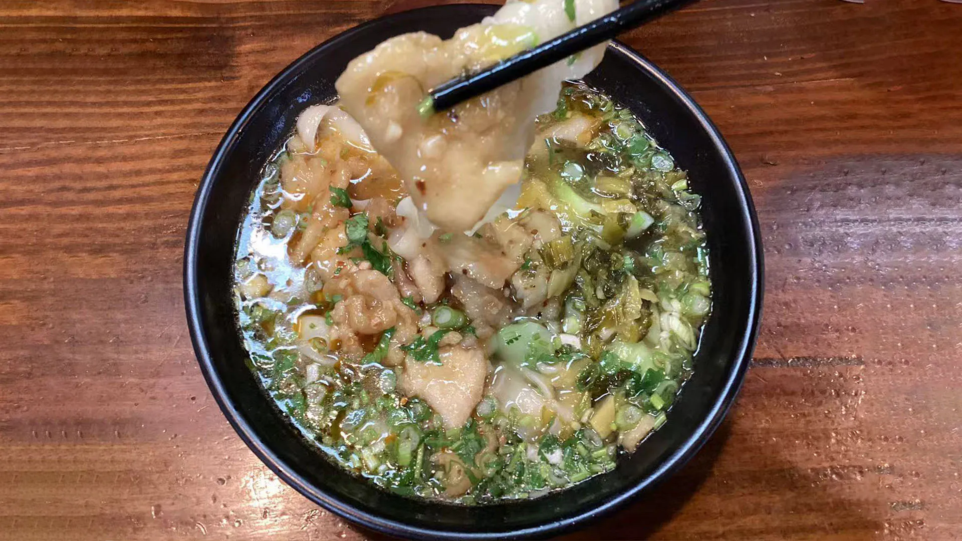 Handmade Shanxi knife sliced noodle soup with tender meat and greens at Noodle Man，a Chinese Restaurant in Virginia Beach