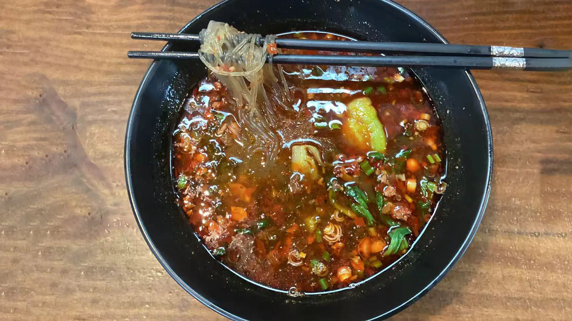 Tangy spicy sour sweet potato vermicelli in rich red broth at Noodle Man，a Chinese Restaurant in Virginia Beach